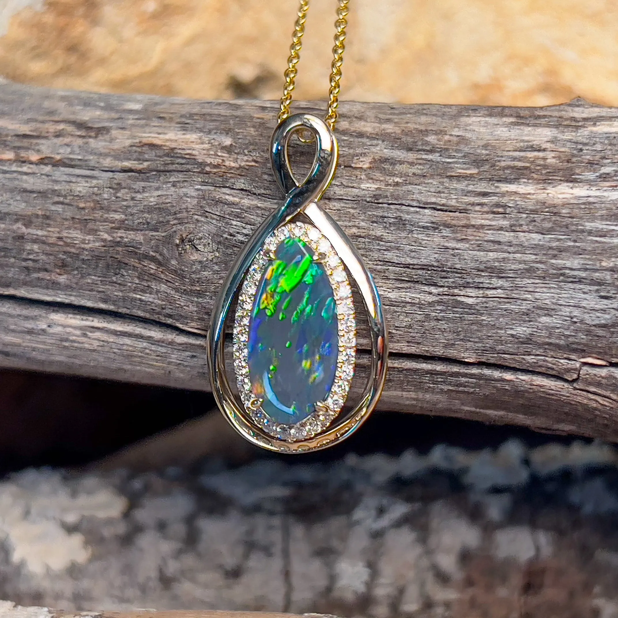 14kt Yellow Gold Infinity design Black Opal pear shape and diamond halo pendant