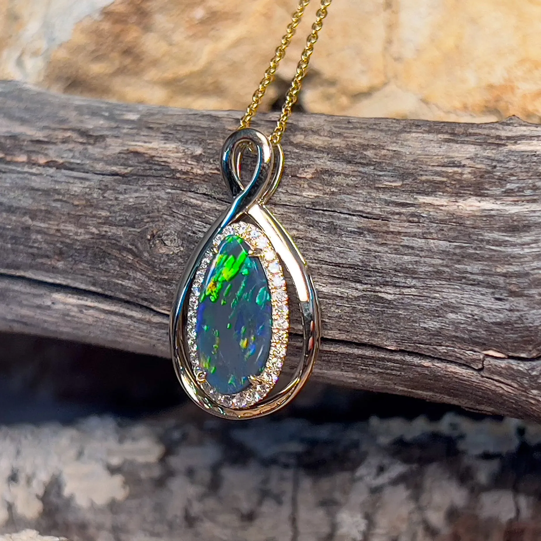 14kt Yellow Gold Infinity design Black Opal pear shape and diamond halo pendant