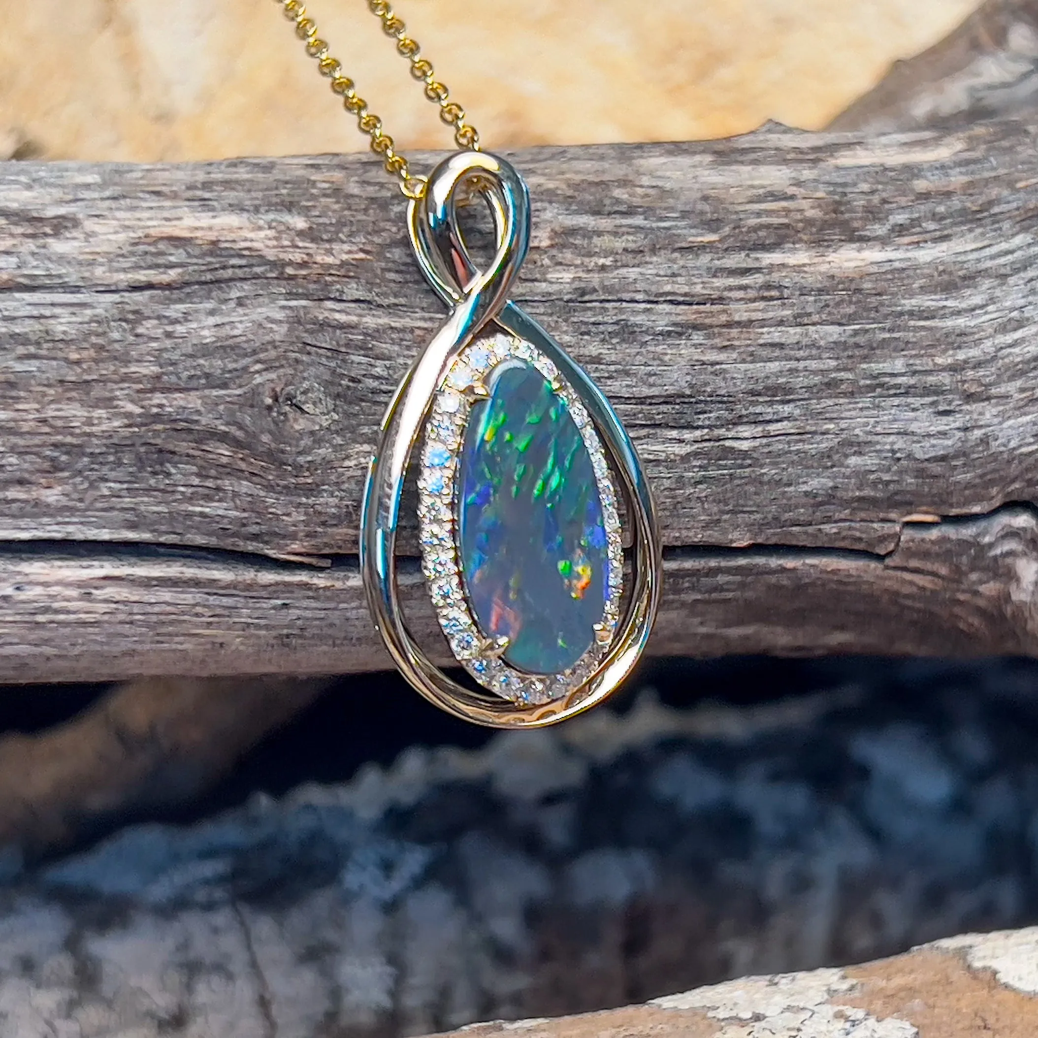 14kt Yellow Gold Infinity design Black Opal pear shape and diamond halo pendant