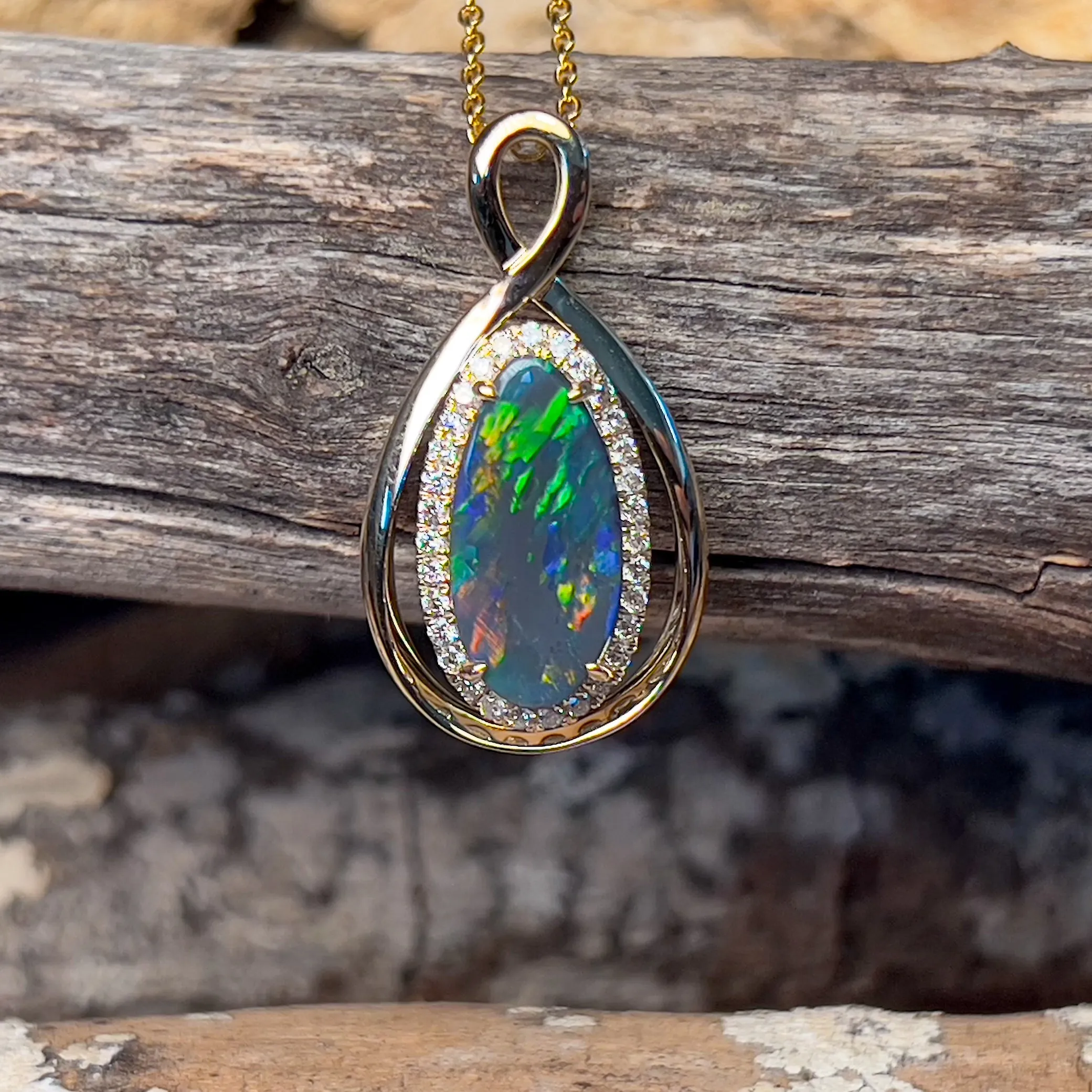 14kt Yellow Gold Infinity design Black Opal pear shape and diamond halo pendant