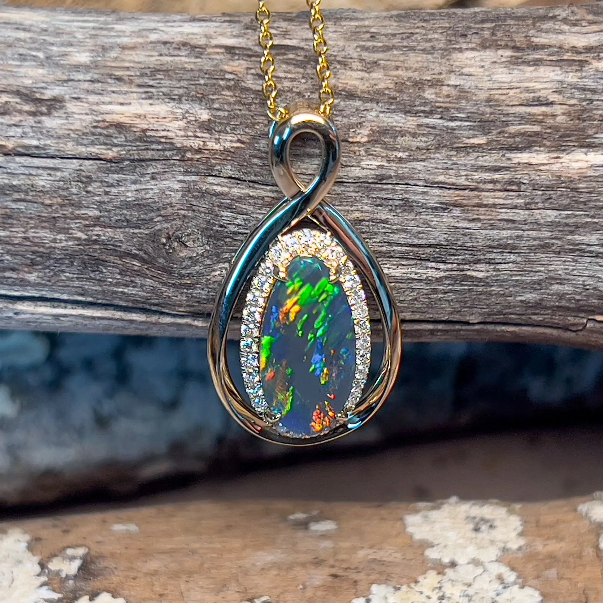 14kt Yellow Gold Infinity design Black Opal pear shape and diamond halo pendant