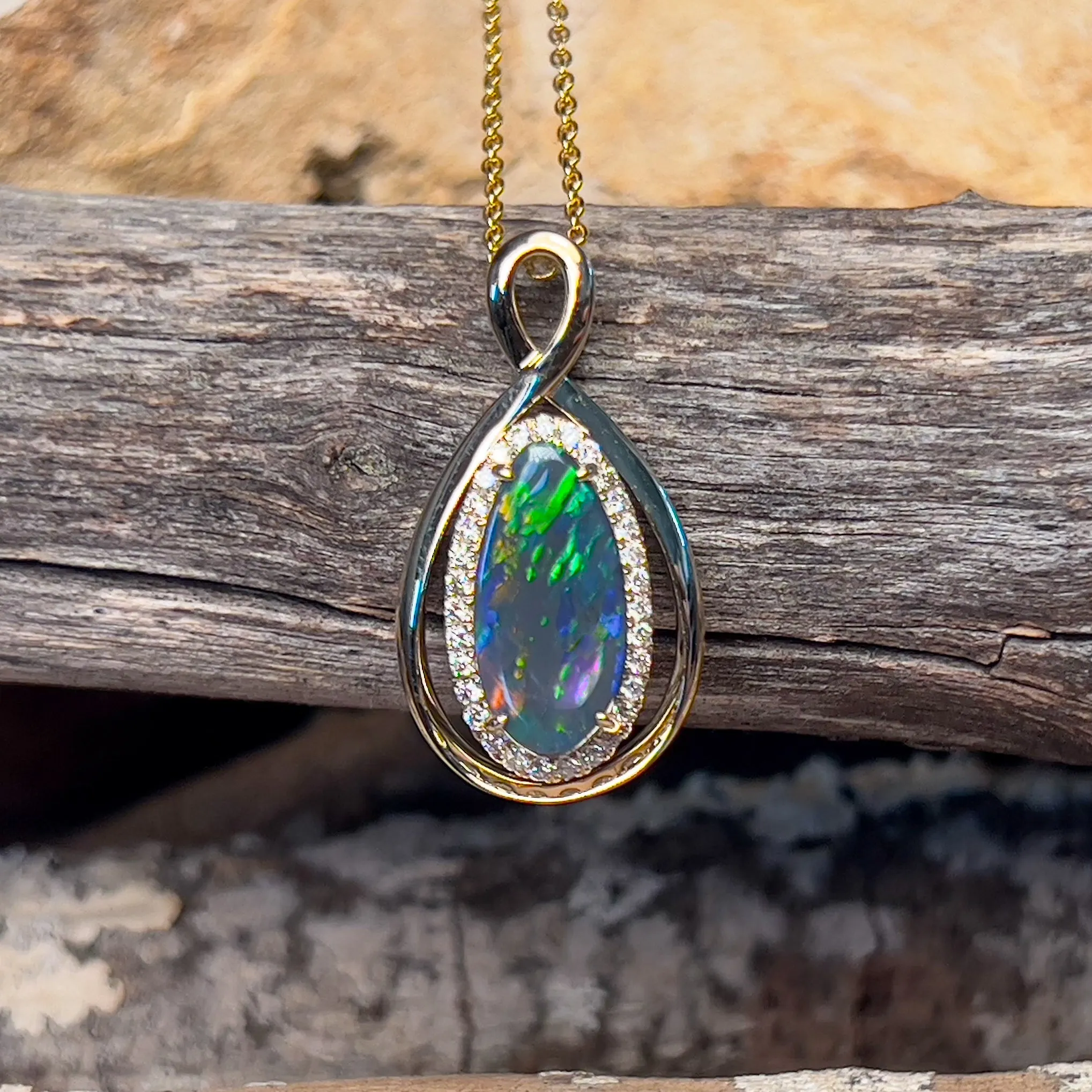 14kt Yellow Gold Infinity design Black Opal pear shape and diamond halo pendant